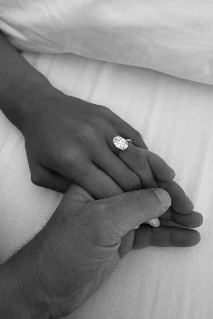 Natalie Kuckenburg shows off her engagement ring while holding hands with Paul Wesley.